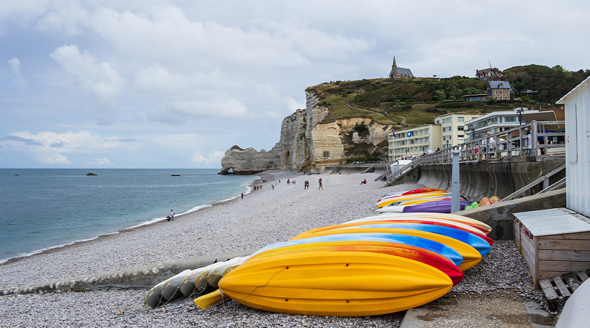 Colourful kayaks on the pebble beach at Étretat